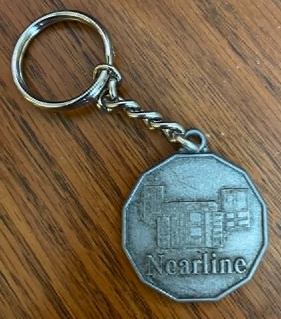 Silver keychain commemorating the Nearline storage system